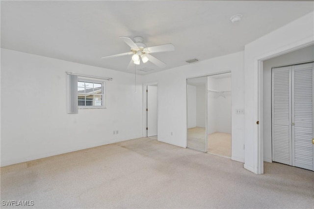 unfurnished bedroom with ceiling fan and light colored carpet