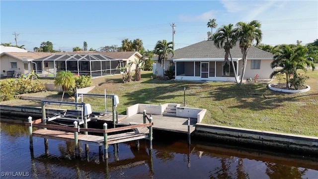 view of dock featuring a lawn and a water view