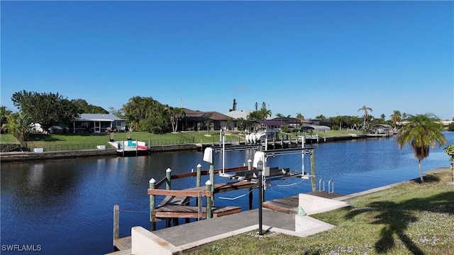 view of dock featuring a water view and a yard