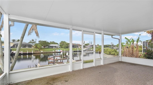 unfurnished sunroom with a water view