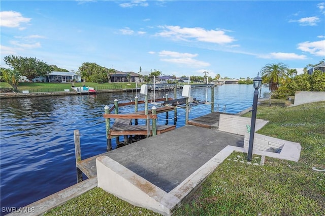 dock area featuring a yard and a water view