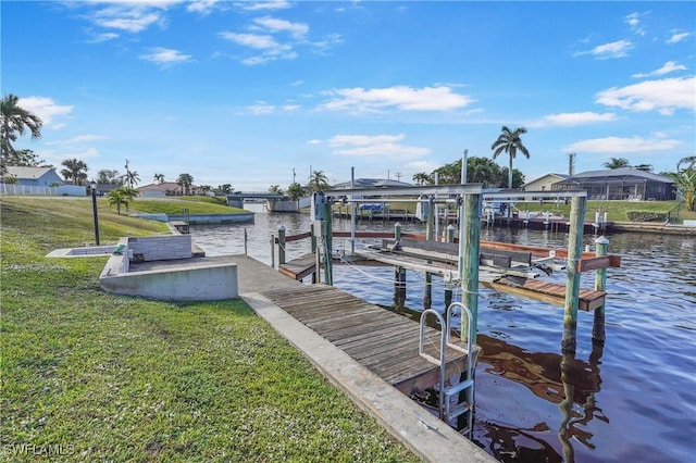 view of dock featuring a yard and a water view