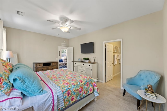 bedroom with light hardwood / wood-style floors and ceiling fan