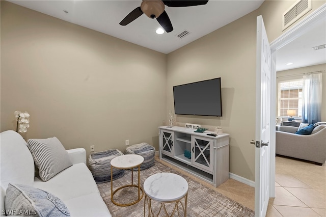 living room with light tile floors and ceiling fan