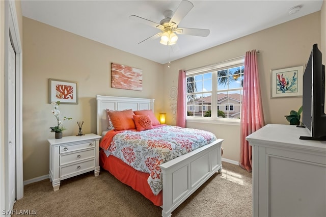 carpeted bedroom featuring a closet and ceiling fan