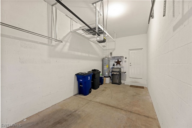 garage with a garage door opener and water heater