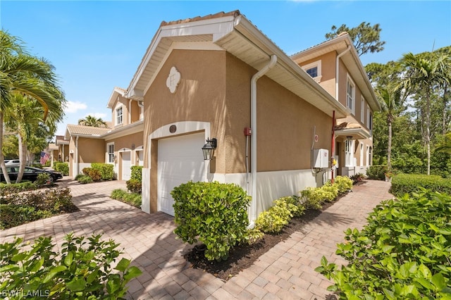 view of side of home with a garage