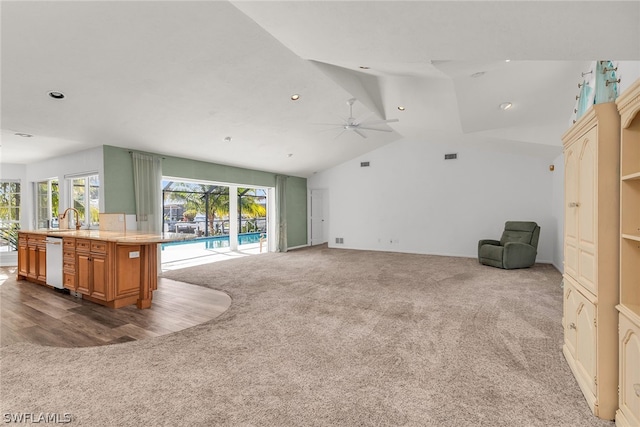 interior space featuring vaulted ceiling, carpet floors, and ceiling fan