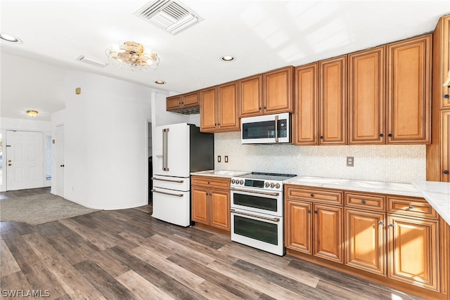 kitchen with premium appliances and dark hardwood / wood-style flooring