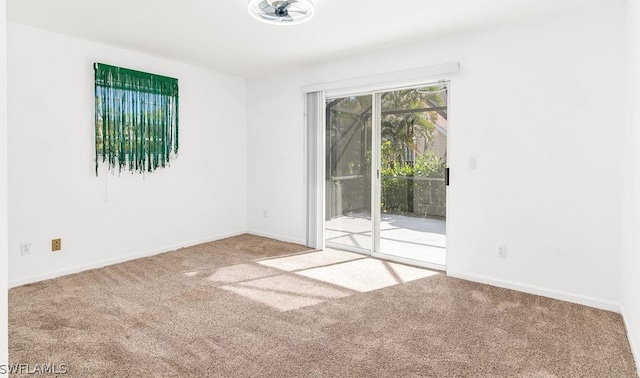 spare room featuring light colored carpet