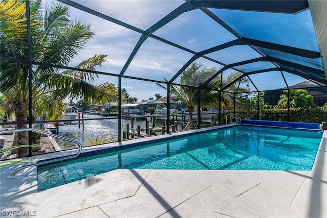 view of swimming pool with a water view, a lanai, and a patio area