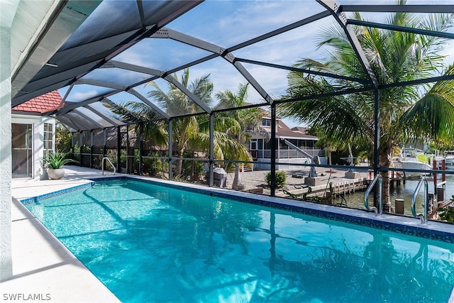 view of swimming pool with glass enclosure and a patio