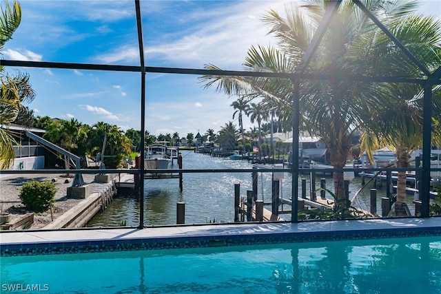 view of swimming pool featuring a water view and a boat dock