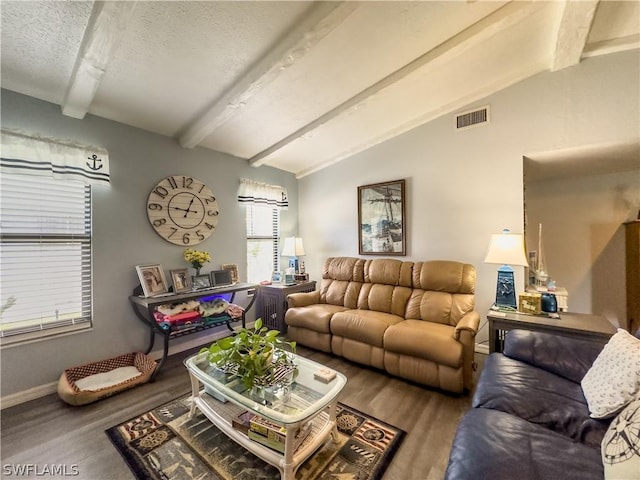 living room featuring hardwood / wood-style flooring, lofted ceiling with beams, and a textured ceiling