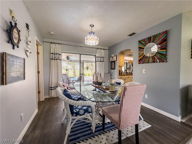 dining room featuring dark hardwood / wood-style floors and a textured ceiling