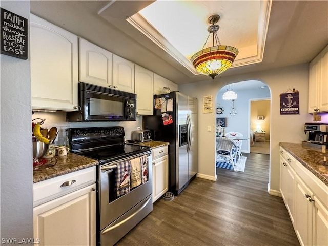 kitchen with white cabinets, pendant lighting, a raised ceiling, and appliances with stainless steel finishes