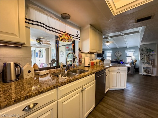 kitchen with dark stone counters, sink, hanging light fixtures, dark hardwood / wood-style floors, and kitchen peninsula