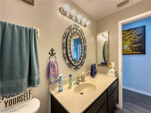 bathroom featuring hardwood / wood-style floors, vanity, and toilet