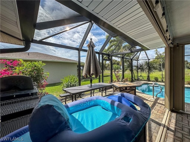 view of pool featuring glass enclosure and a patio