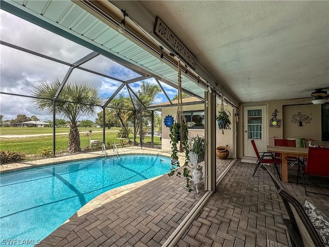 view of swimming pool with a patio area and a lanai