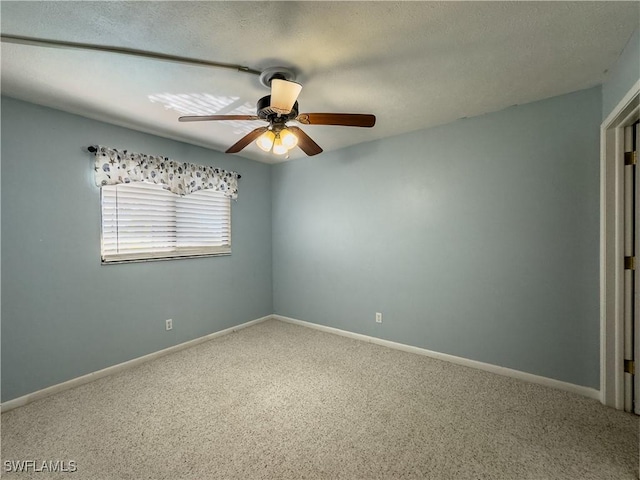 spare room with ceiling fan, carpet, and a textured ceiling