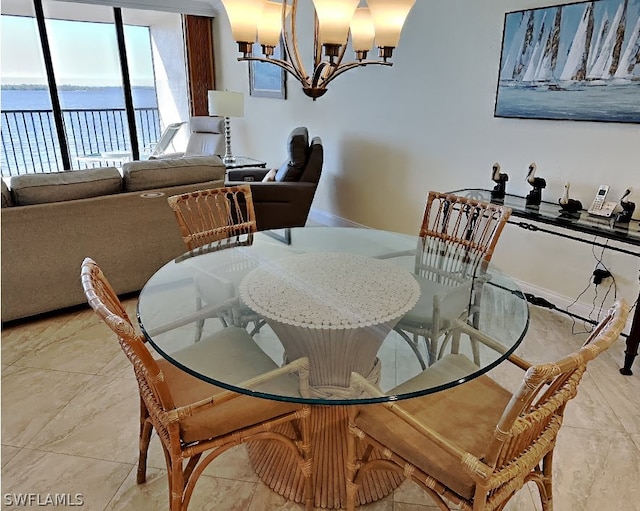 dining space with light tile flooring, a water view, and a notable chandelier