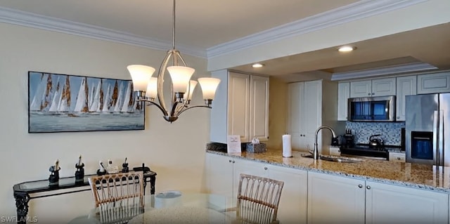 kitchen with a chandelier, decorative light fixtures, light stone countertops, tasteful backsplash, and appliances with stainless steel finishes