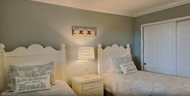 bedroom with ornamental molding and a closet