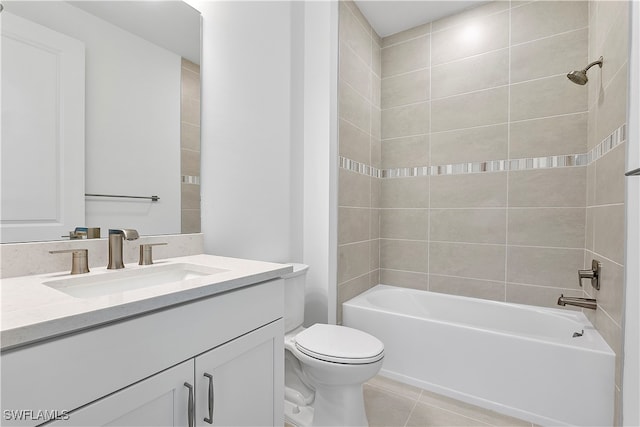 full bathroom featuring vanity, tiled shower / bath combo, tile patterned floors, and toilet