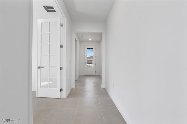 hall featuring light tile patterned floors