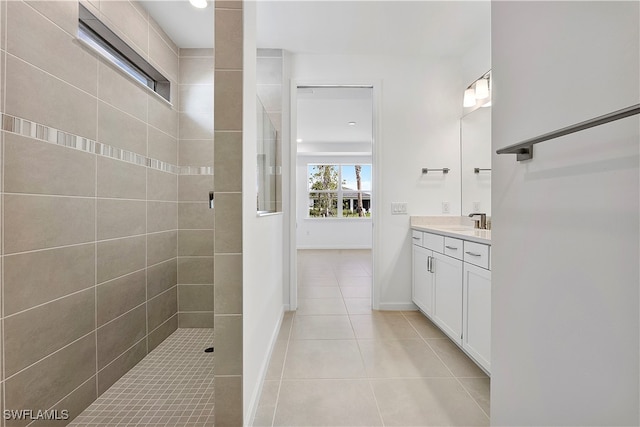 bathroom featuring tiled shower, vanity, and tile patterned floors