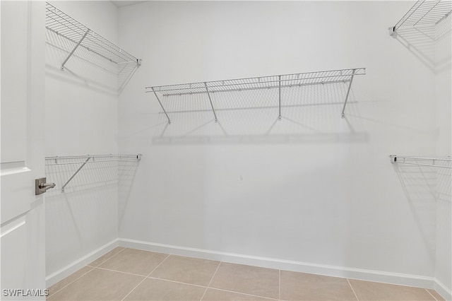 spacious closet with tile patterned floors