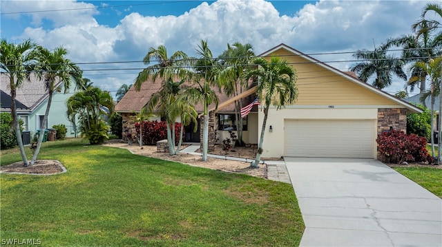 view of front of property with a front yard, a garage, and central AC unit