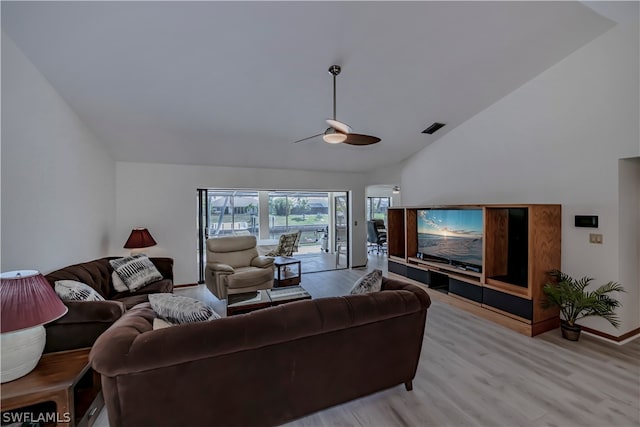 living room featuring high vaulted ceiling, ceiling fan, and light wood-type flooring