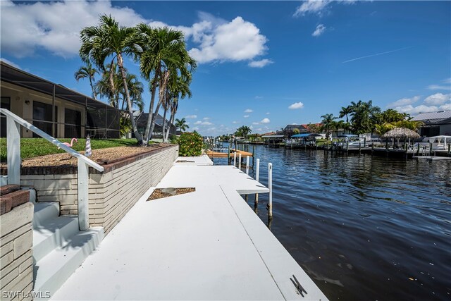 dock area with glass enclosure and a water view