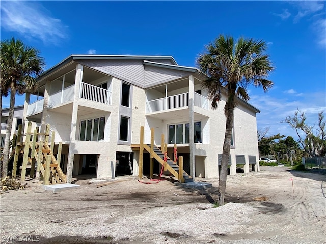 back of property featuring a balcony