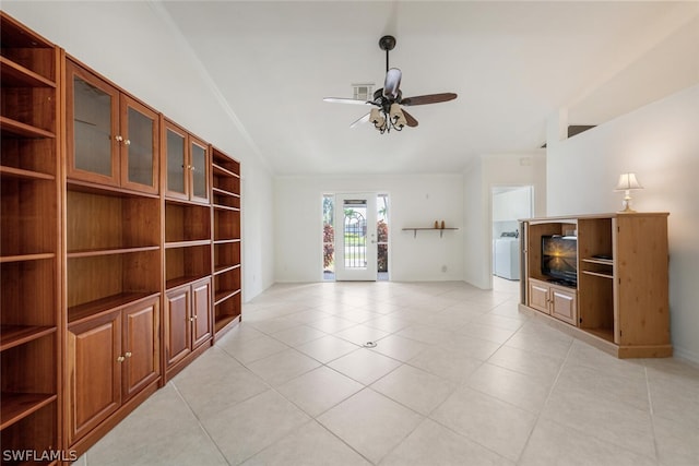 unfurnished living room with vaulted ceiling, ceiling fan, and light tile floors