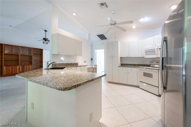 kitchen featuring ceiling fan, light tile floors, sink, white appliances, and kitchen peninsula