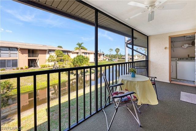 balcony with separate washer and dryer and ceiling fan