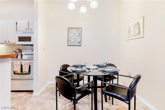 dining area with a chandelier and light tile flooring