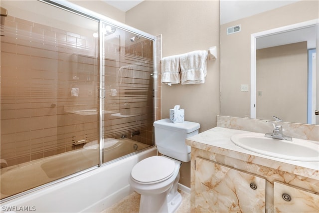 full bathroom with combined bath / shower with glass door, toilet, and vanity