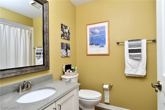 bathroom with toilet and vanity