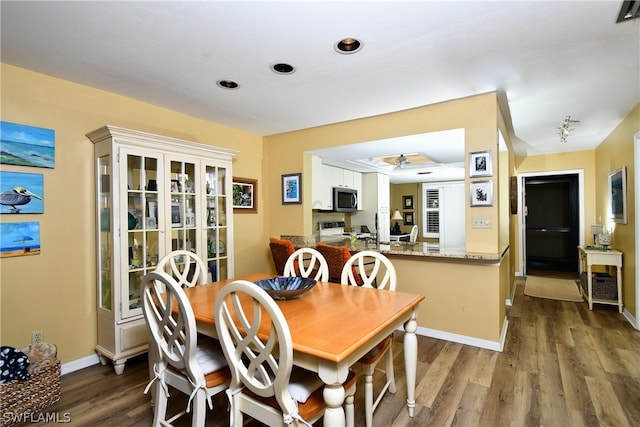 dining room featuring dark hardwood / wood-style floors and ceiling fan