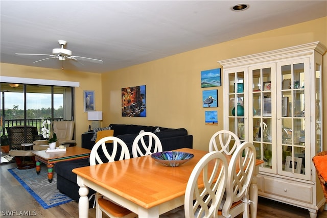 dining space with dark hardwood / wood-style flooring and ceiling fan