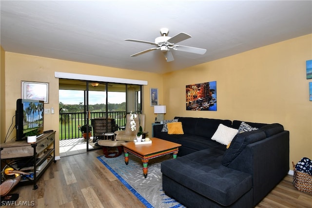 living room featuring ceiling fan and light wood-type flooring