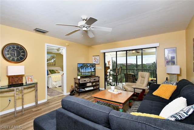 living room featuring light hardwood / wood-style floors and ceiling fan