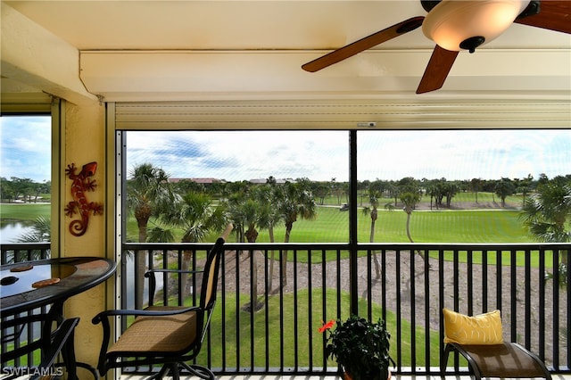 sunroom featuring ceiling fan