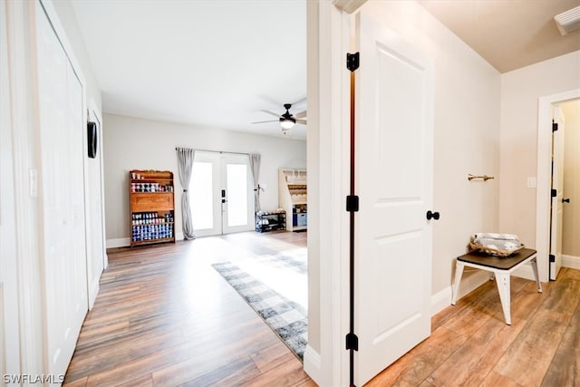 hall featuring light hardwood / wood-style floors and french doors