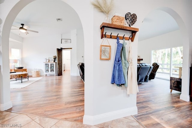 corridor featuring light hardwood / wood-style floors and vaulted ceiling