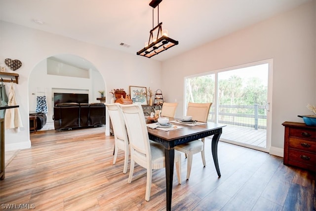 dining room featuring an inviting chandelier and light wood-type flooring